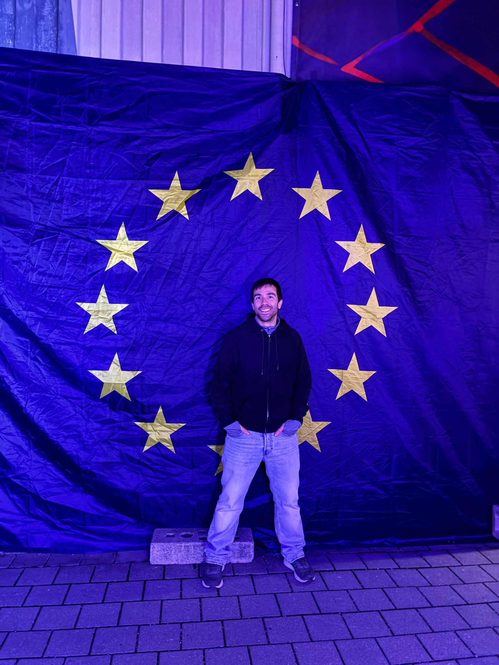 Pedro in front of the EU flag at the PROTOTYPE event in Berlin