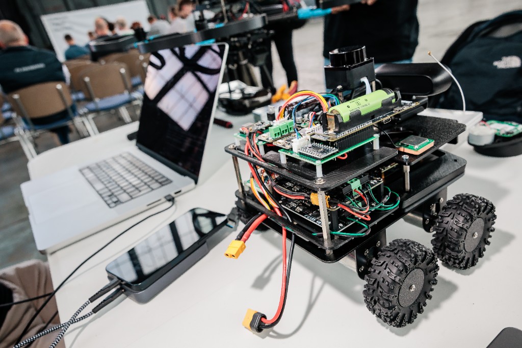 Close-up of the UBR ground robot on a white table with a laptop