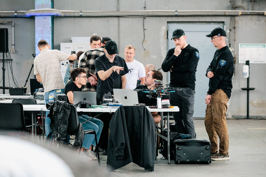 UBR team and partners gathered around the demo table